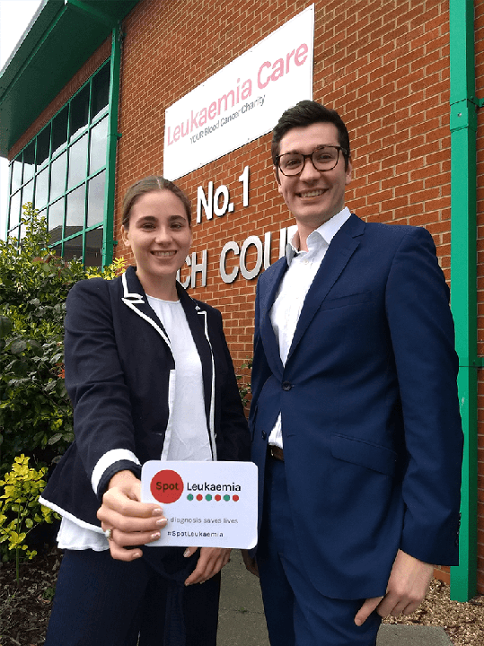 Bethany Torr and Zack Pemberton-Whiteley from Leukaemia Care with the leukaemia symptoms card.