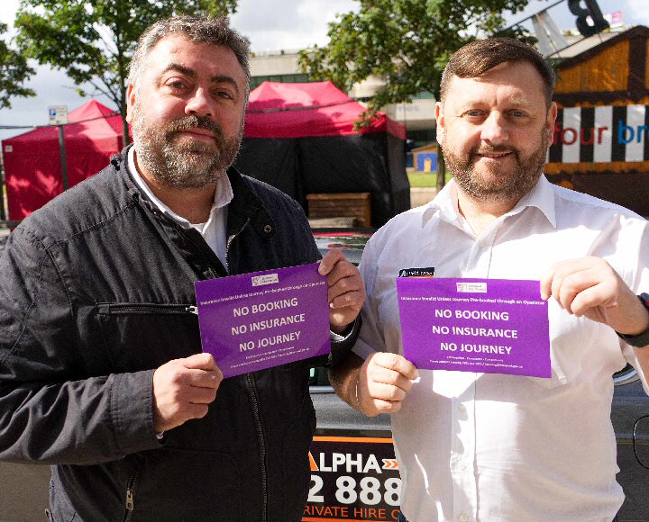 Liverpool City Councils Cabinet Member for Transport Cllr James Noakes shows off the new signs with Alpha Operations Manager Liam Sweeney.