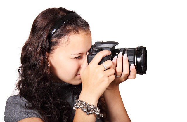 Girl holds camera to advertise Crosby Schools Photographic Competition