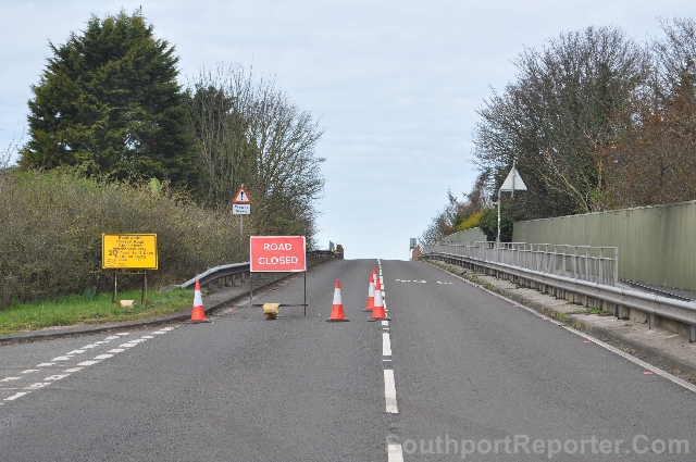 Road closure notice on Rail Bridge over the Mersey Rail Northern Line next to Pinfold Lane.