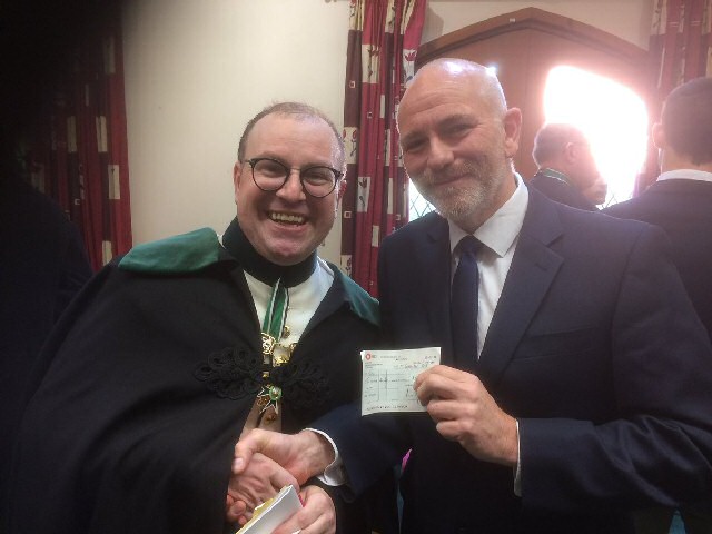 Pictured (l-r): The Orders Grand Prior, Anthony Dickinson, presents a cheque to Mike Parr, Chief Executive of St. Josephs Hospice in Thornton.