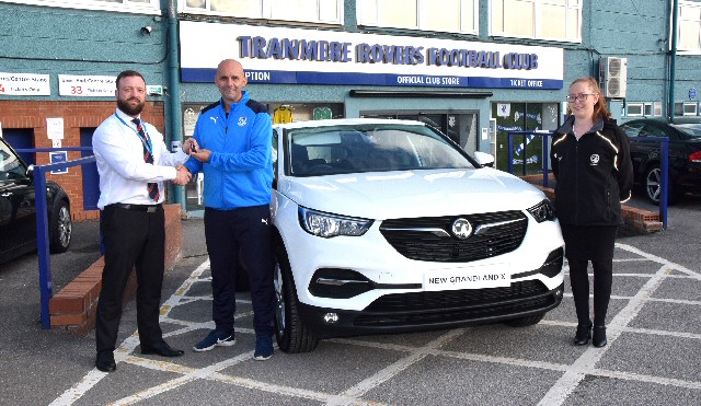 New Car Sales Manager Matt Edwards hands over the keys to Tranmere Rovers Assistant Coach Shaun Garnett, along with Super Whites fan Gabrielle Porter, sales consultant.