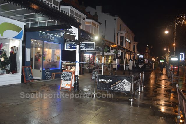 Photograph shows Police cordon tape next to the Corridor Bar, Southport, in front of Wright’s Jewellers.