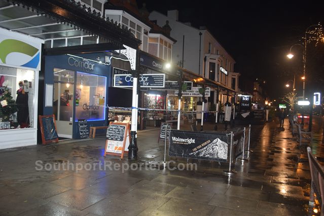 Photograph shows Police cordon tape next to the Corridor Bar, Southport, in front of Wrights Jewellers.