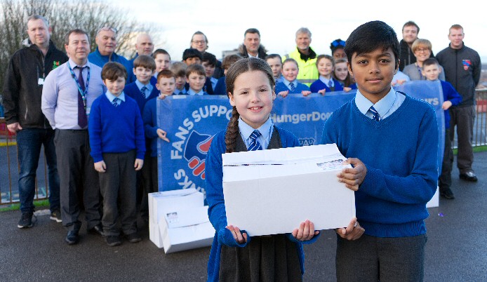 The photo shows Year 4 pupils Katie and Aayman doing their bit along with the rest of the volunteers.