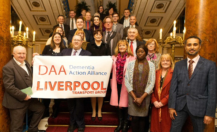 Photo - Motion Carried -- Councillor Jeremy Wolfson, Mayoral Lead for Older People (South) is joined by representatives from the Dementia Action Alliance's Transport Group, including Pat Broster and Tommy Dunne and Liverpool City Councillors at this week's full Council meeting where the motion on Age Friendly Liverpool was debated.