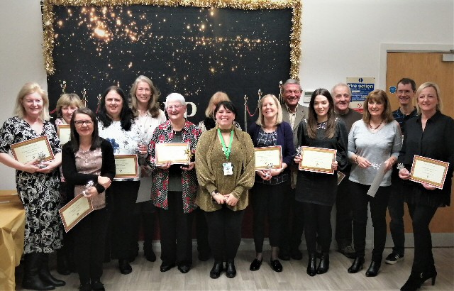 Photo shows the NSPCC award winners holding certificates.