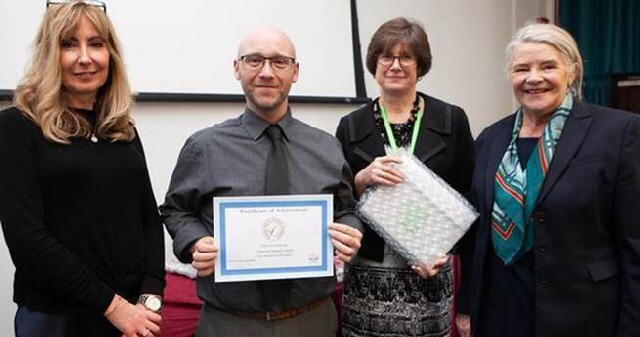 Quality Counts: Adam Kewn accepts the Attendance Mark on behalf of Heygreen Primary School in Wavertree from Carolyn Harkness from the attendance mark scheme, Gail Porter from Liverpool City Council and Cllr Barbara Murray.