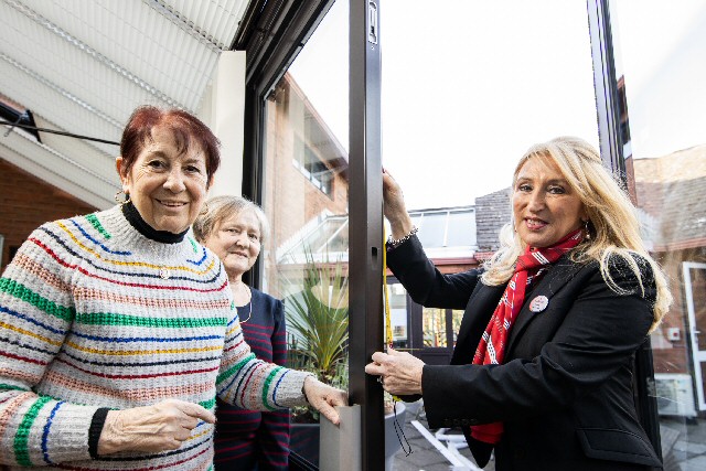 Caption: Redrows Yvonne Gaskill helps Anita Johnson and Joan Jones measure up for new blinds for The Marie Curie Hospice, Liverpool